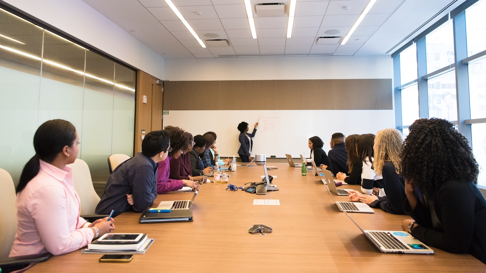 A leadership team reviewing findings around a conference table, illustrating AI risk reported in financial terms