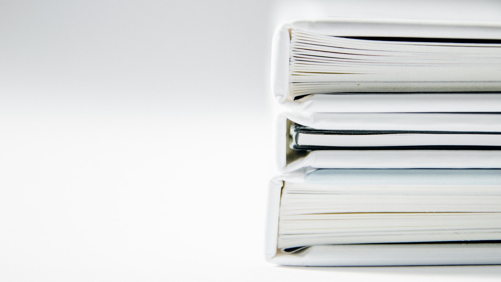 Thick stacks of folders representing the cost of manual evidence collection