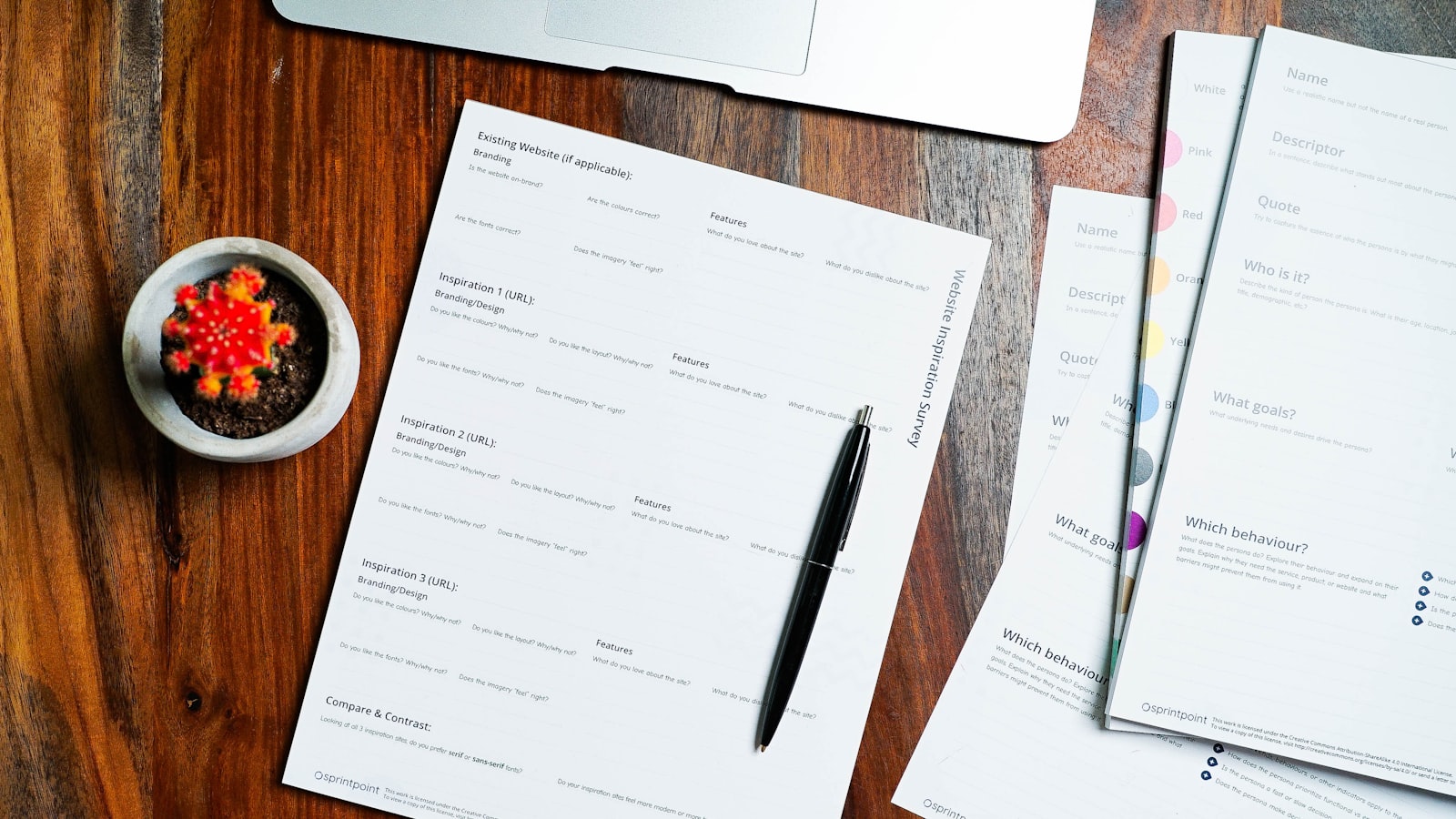 A pen and papers on a desk, representing structured impact assessment