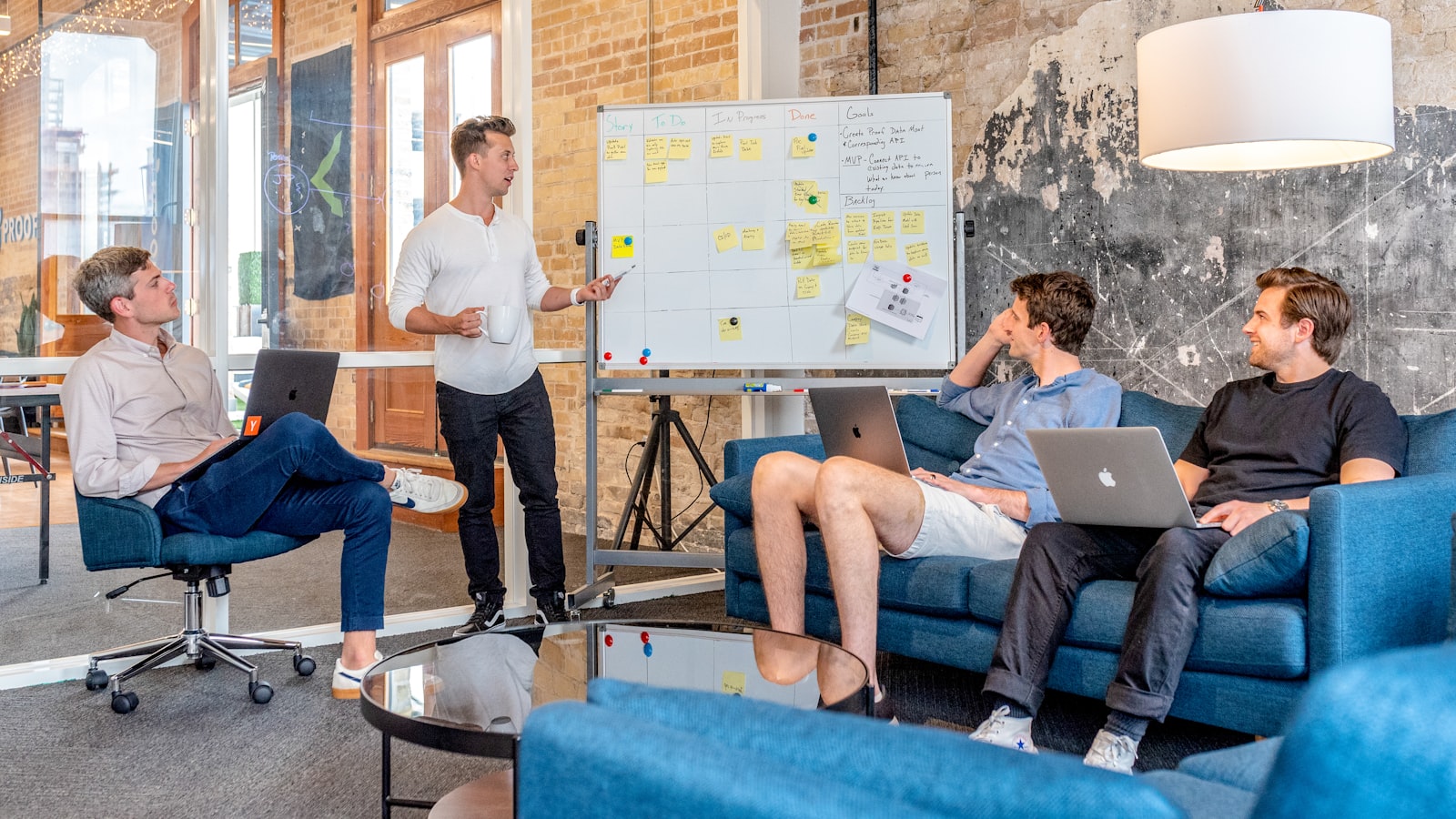 Colleagues working through a policy at a whiteboard session
